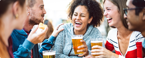 A group of friends laughing and enjoying beer together